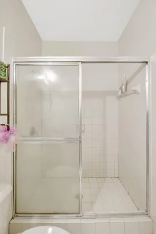 a bathroom with a glass shower door