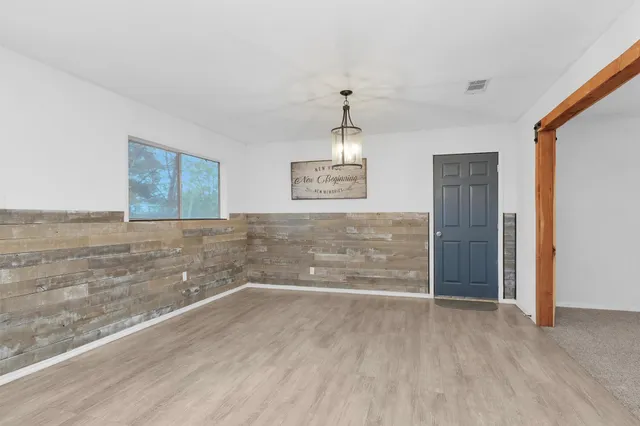 a view of a kitchen with wooden floor and a sink