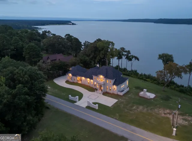 an aerial view of a house with a yard