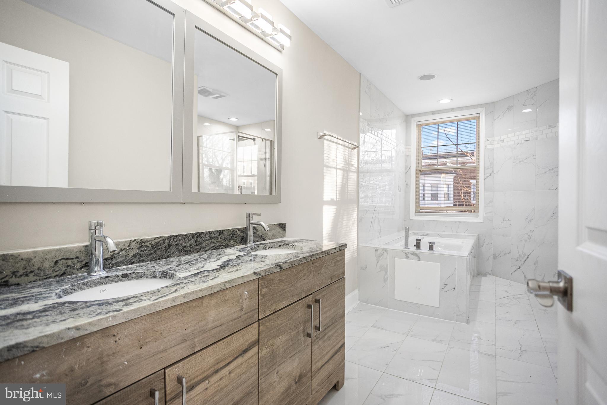 3200 Chelsea Terrace Baltimore, MD 21216 - Photo 17 of 48 a bathroom with a granite countertop sink mirror and bathtub