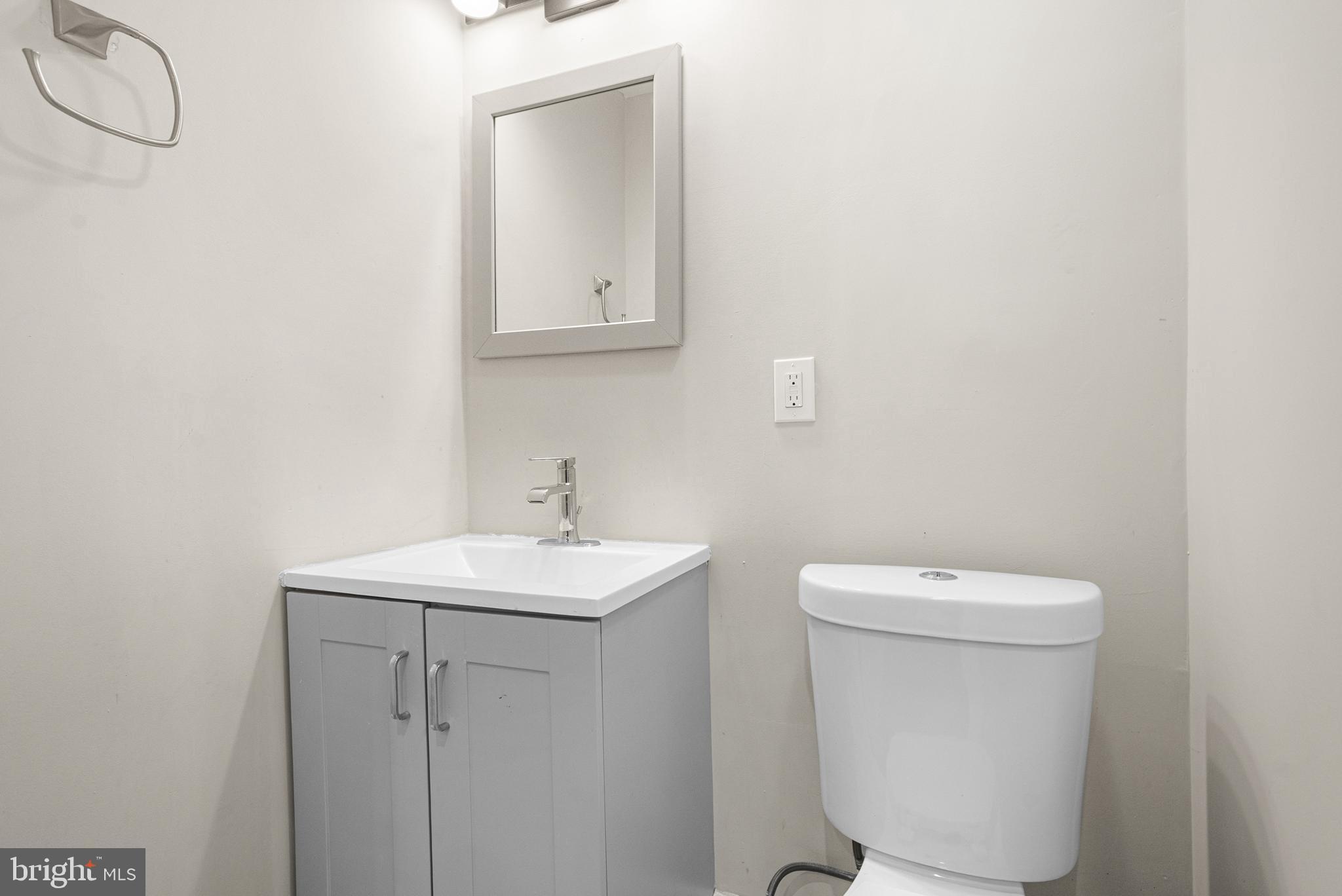 3200 Chelsea Terrace Baltimore, MD 21216 - Photo 45 of 48 a bathroom with a toilet sink and mirror