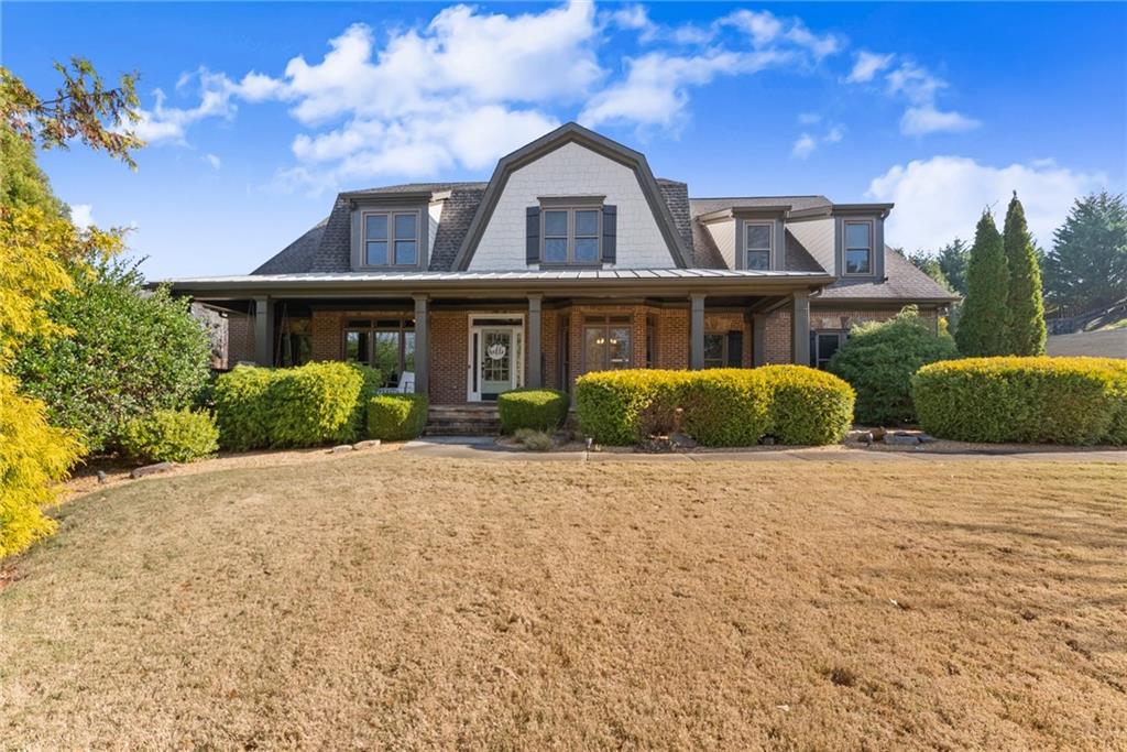 a front view of a house with a garden