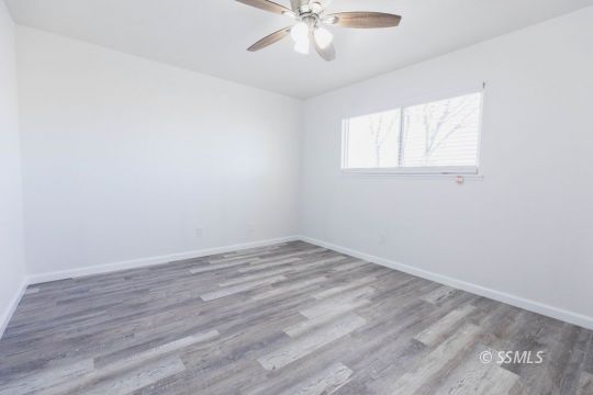 901 West Rader Avenue Ridgecrest, CA 93555 - Photo 19 of 26 wooden floor in an empty room with a window