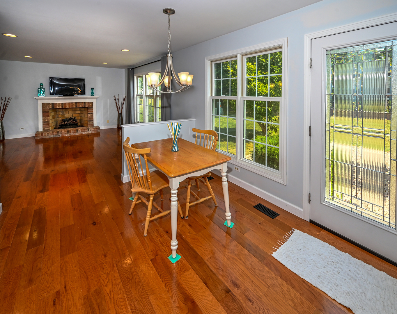 413 Rugby Place Schaumburg, IL 60169 - Photo 12 of 30 a room with wooden floors table and windows