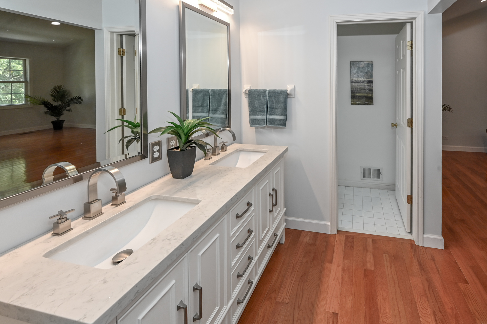 413 Rugby Place Schaumburg, IL 60169 - Photo 19 of 30 a bathroom with a double vanity sink a mirror and a shower