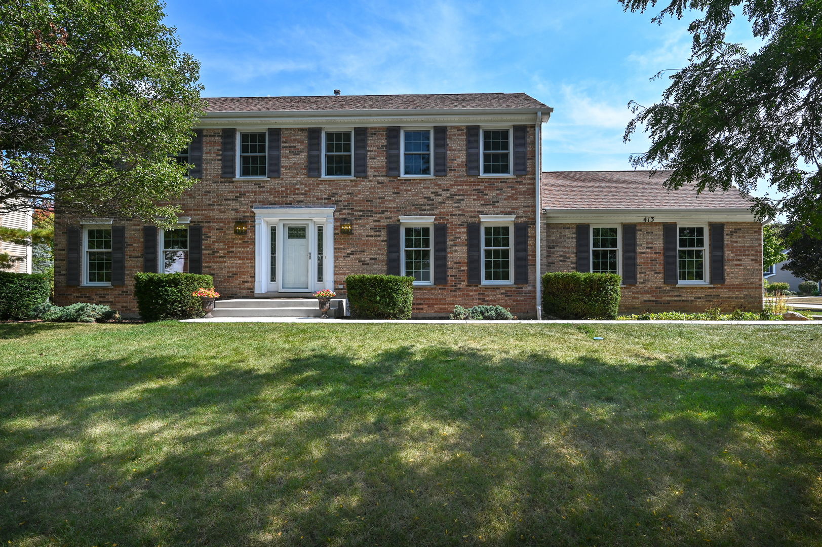 413 Rugby Place Schaumburg, IL 60169 - Photo 2 of 30 a front view of a house with a yard and garage