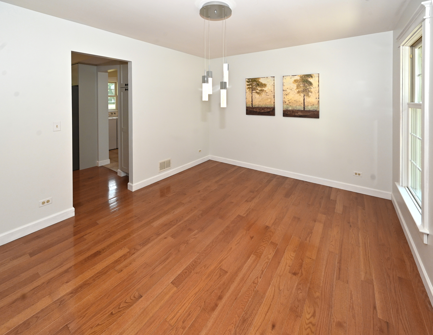 413 Rugby Place Schaumburg, IL 60169 - Photo 6 of 30 an empty room with wooden floor and windows