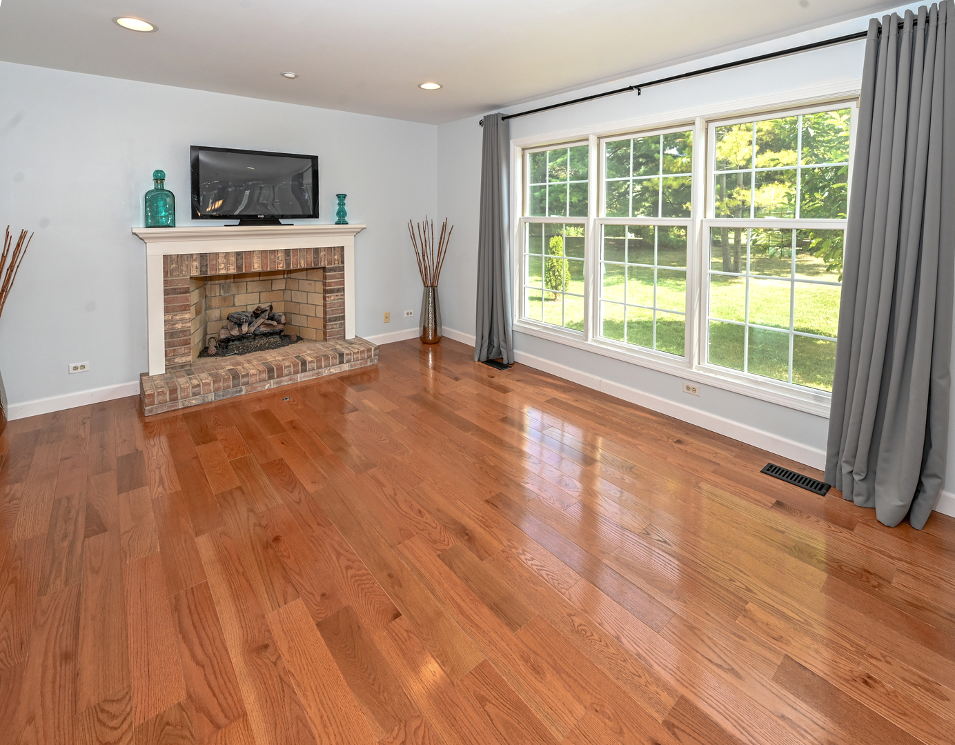413 Rugby Place Schaumburg, IL 60169 - Photo 9 of 30 a view of empty room with wooden floor and fireplace