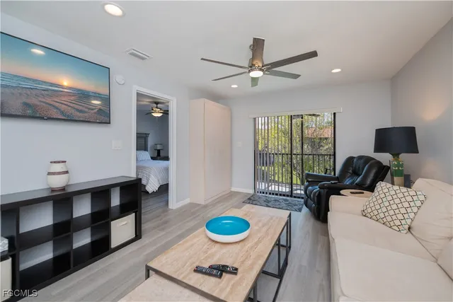 a living room with furniture and a floor to ceiling window