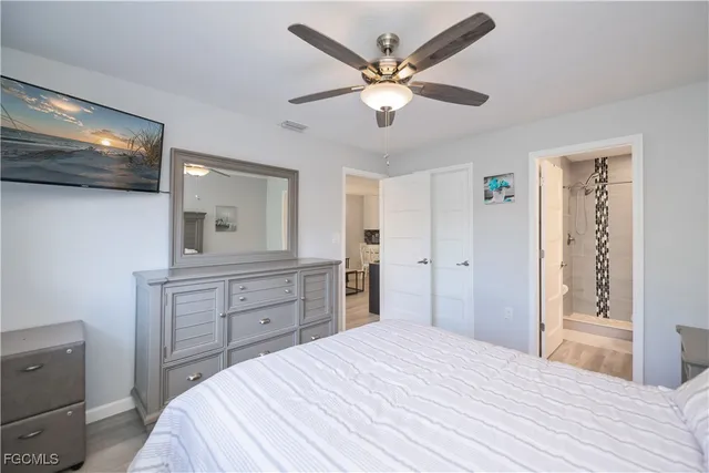 a bedroom with a bed and a mirror on dresser