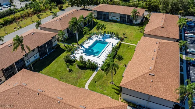 an aerial view of a house with a garden and swimming pool
