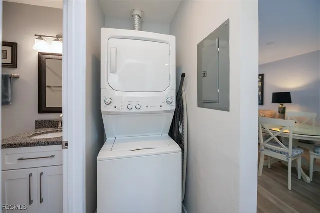 a utility room with dryer washer and a view of living room