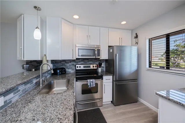 a kitchen with a refrigerator sink and microwave