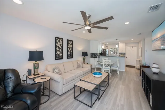 a living room with furniture and a wooden floor