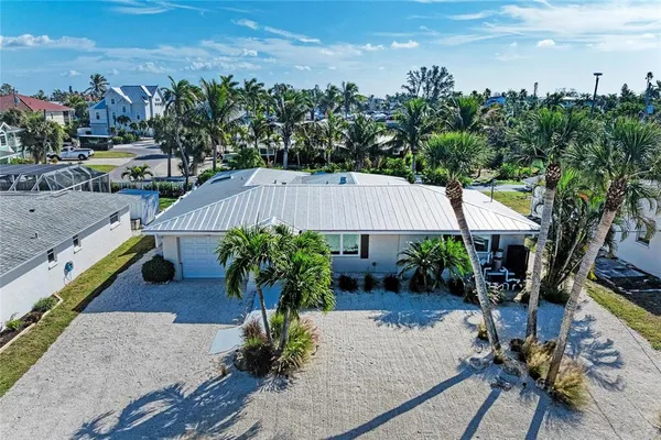 an aerial view of a house with garden space and outdoor seating