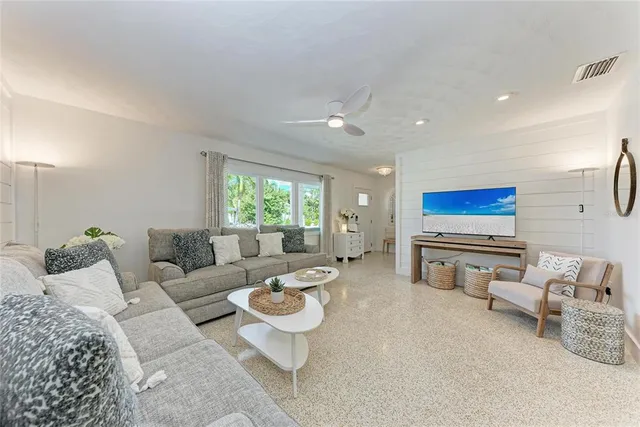 a kitchen with kitchen island a appliances dining table and chairs