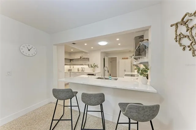 a kitchen with a refrigerator and microwave