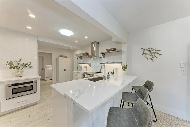 a kitchen with a sink and a refrigerator