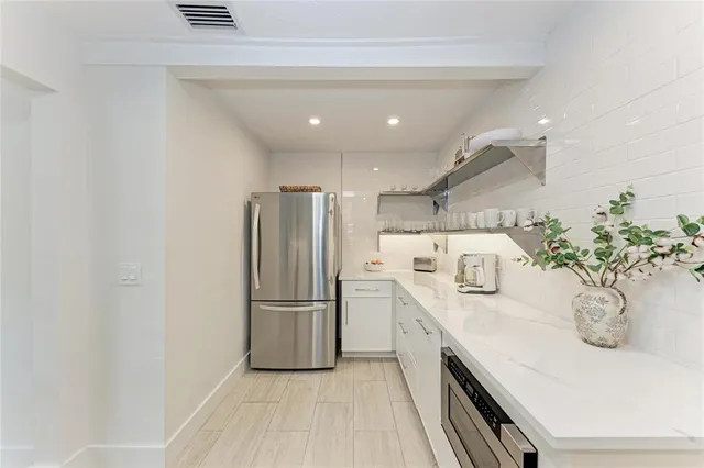 a kitchen with a sink stainless steel appliances and counter space