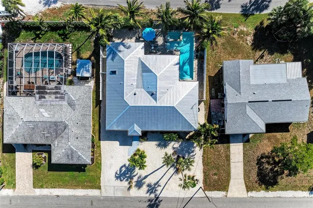 an aerial view of multiple houses with a yard