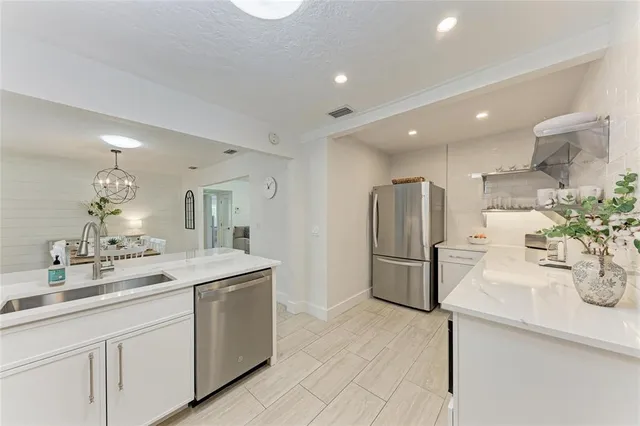 a view of a dining room with furniture a chandelier and wooden floor