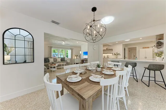 a living room with furniture a table and a potted plant