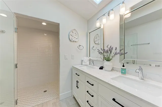 a bedroom with a bed potted plant and a large window