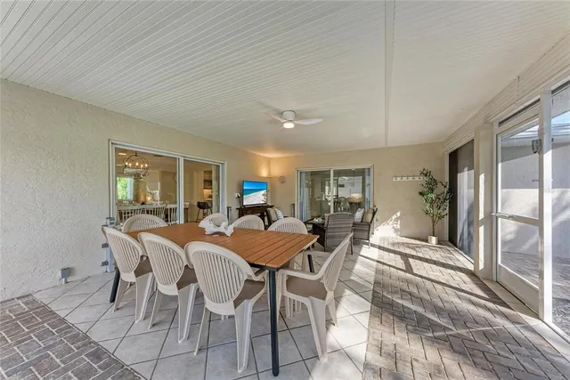 a view of a balcony with wooden floor and a potted plant