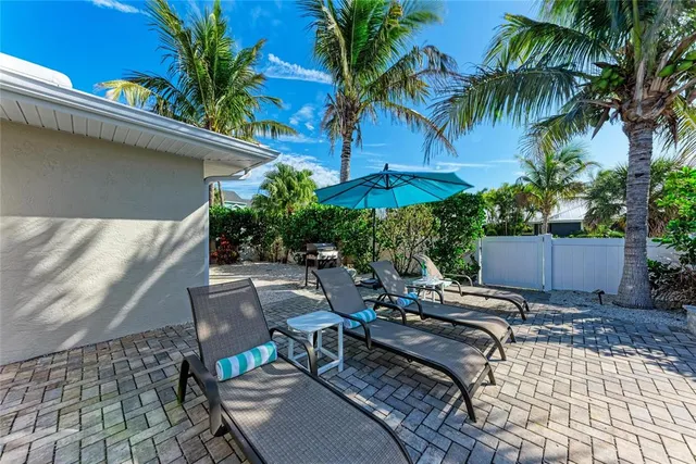 a view of a house with backyard patio and swimming pool