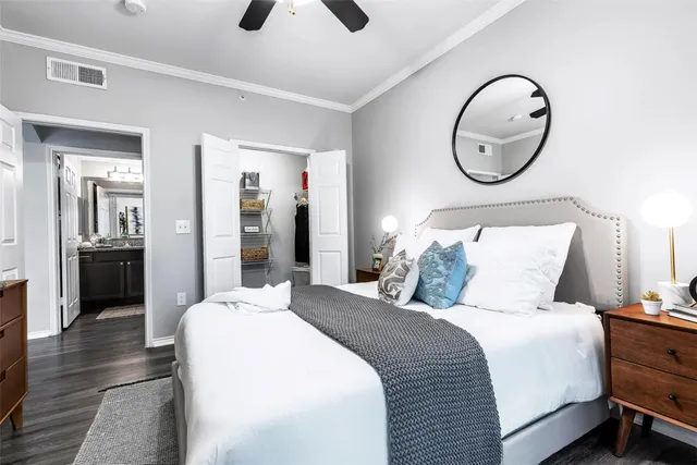 a bedroom with bed and a chandelier