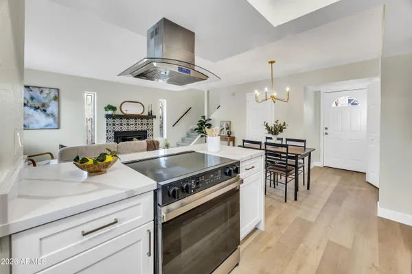a kitchen with a stove and a wooden floors