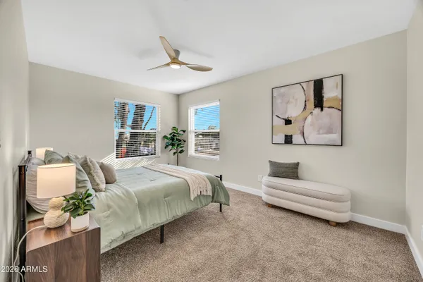 a spacious bedroom with a bed and a couch