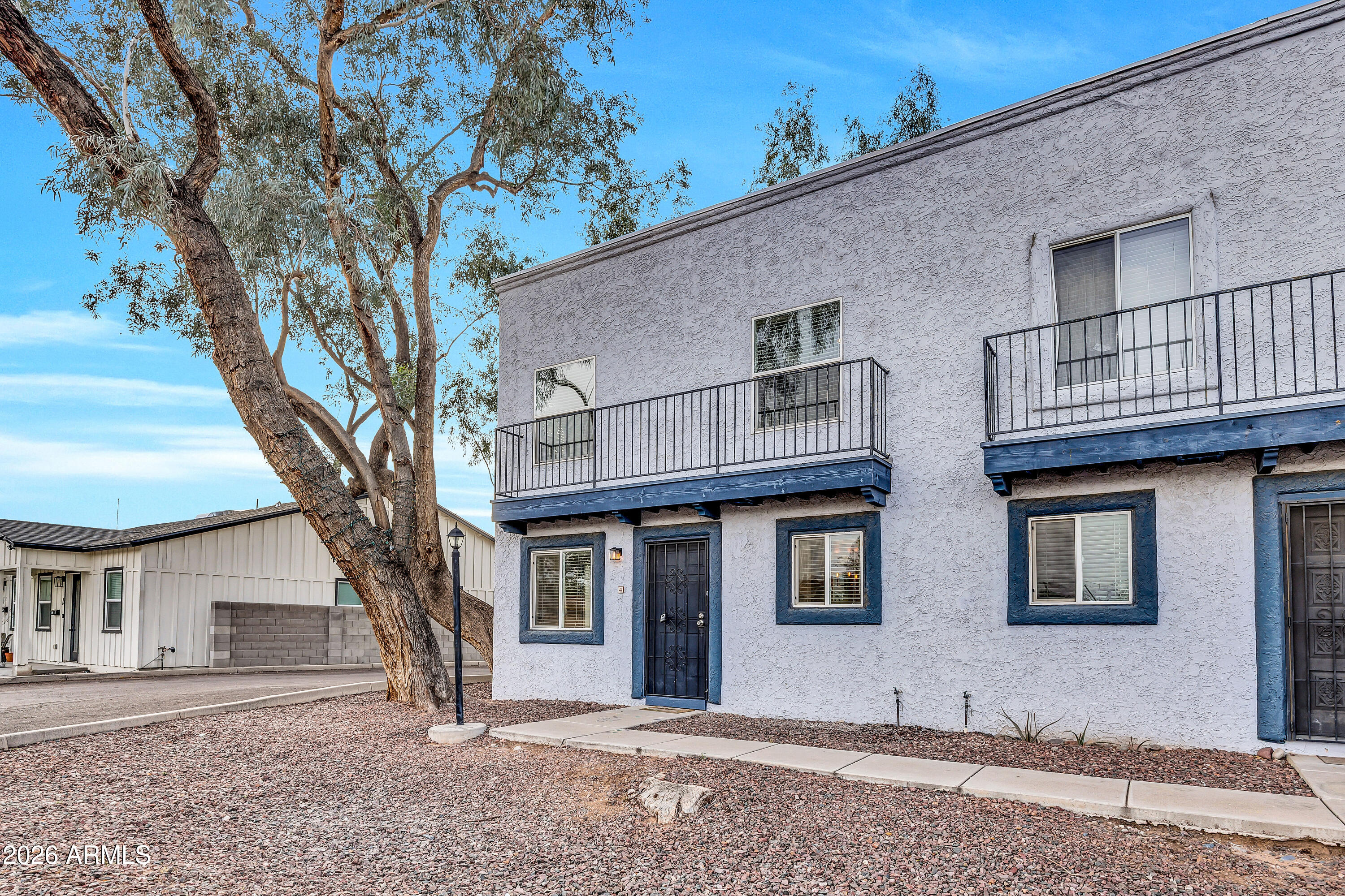 4142 North 11th Street, Unit 4 Phoenix, AZ 85014 - Photo 2 of 25 a front view of a house with a tree