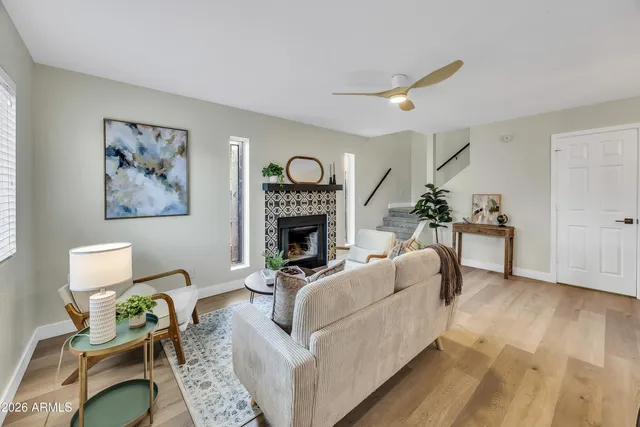 a living room with furniture and a fireplace