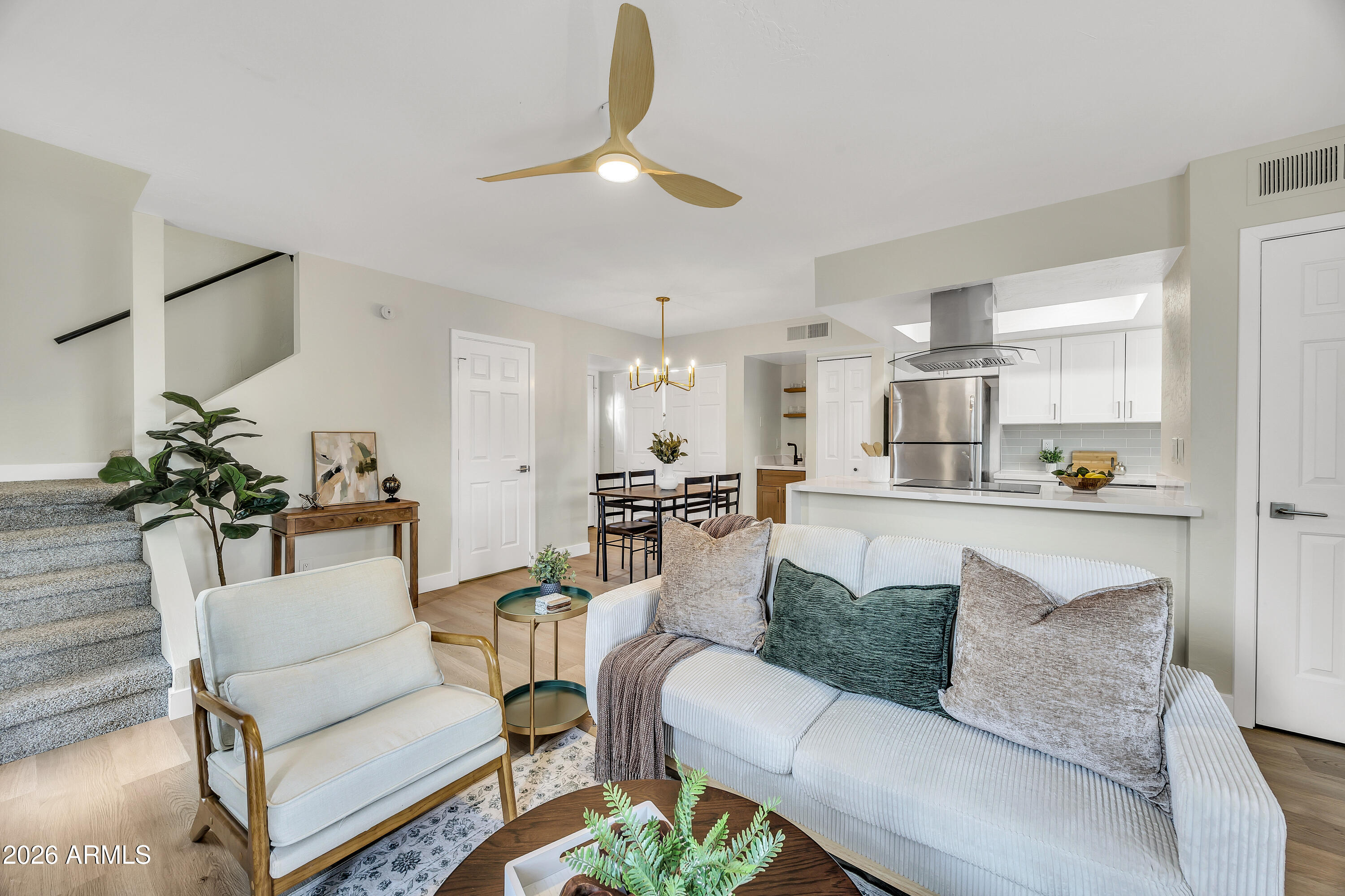 4142 North 11th Street, Unit 4 Phoenix, AZ 85014 - Photo 7 of 25 a living room with furniture and a dining table with kitchen view
