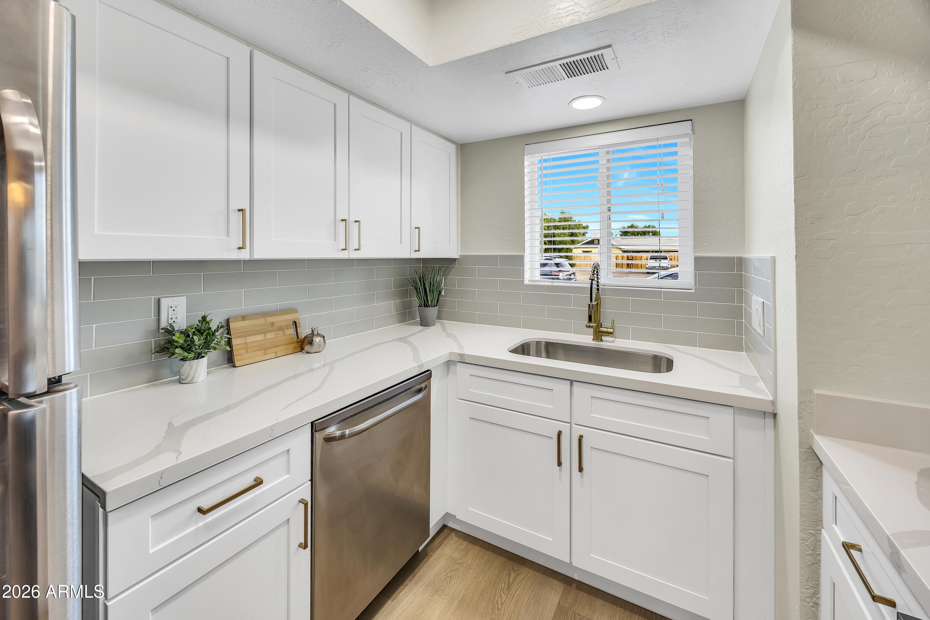 4142 North 11th Street, Unit 4 Phoenix, AZ 85014 - Photo 10 of 25 a kitchen with white cabinets and white appliances