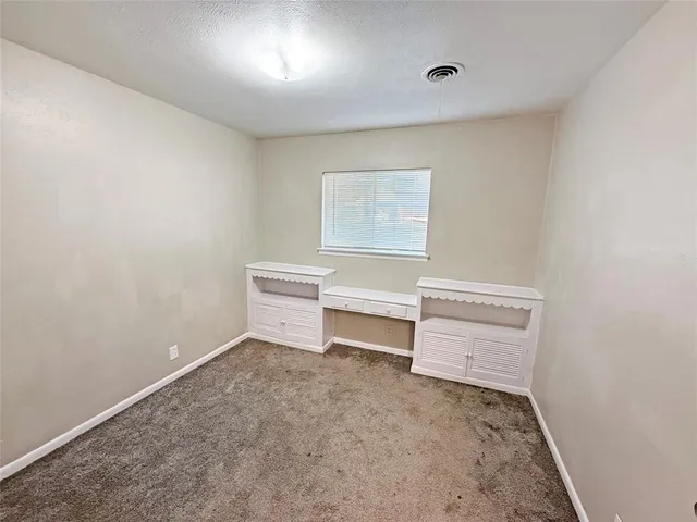 a house that has a tree in front of it