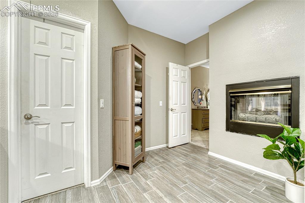 15585 Falcon Ridge Court Colorado Springs, CO 80921 - Photo 22 of 50 a view of a hallway with wooden floor and a living room
