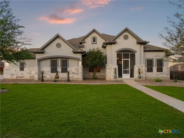 a front view of a house with a yard