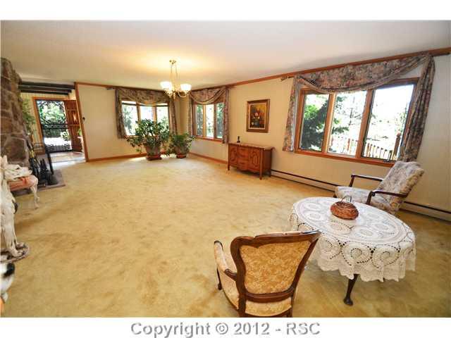 11685 Howells Road Colorado Springs, CO 80908 - Photo 3 of 16 27X17 LIVING ROOM WITH A TILED ENTRY FOYER.