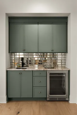 a kitchen with a sink cabinets and stainless steel appliances