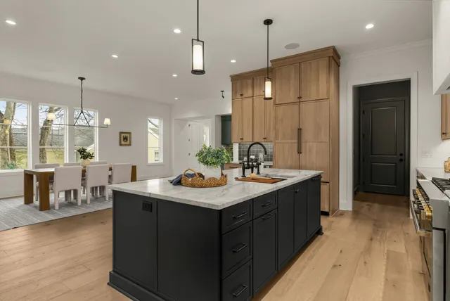 a kitchen with center island table and chairs