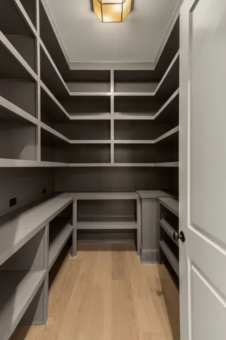 a view of walk in closet with empty racks
