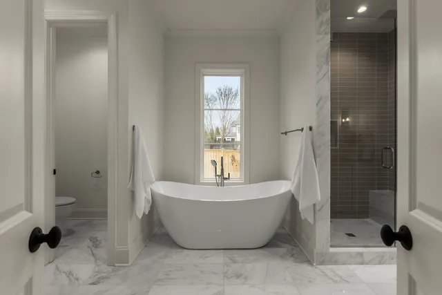 a bathroom with a bathtub and shower