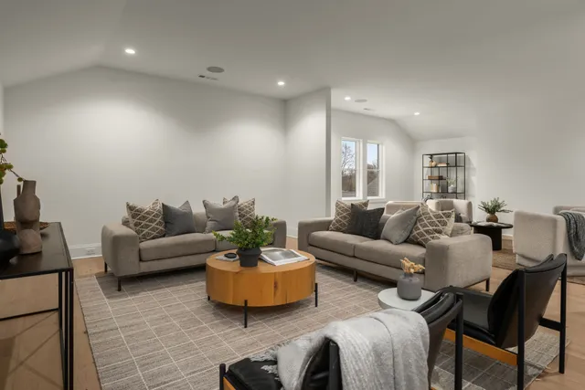 a living room with furniture and a potted plant