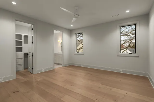 an empty room with windows and closet