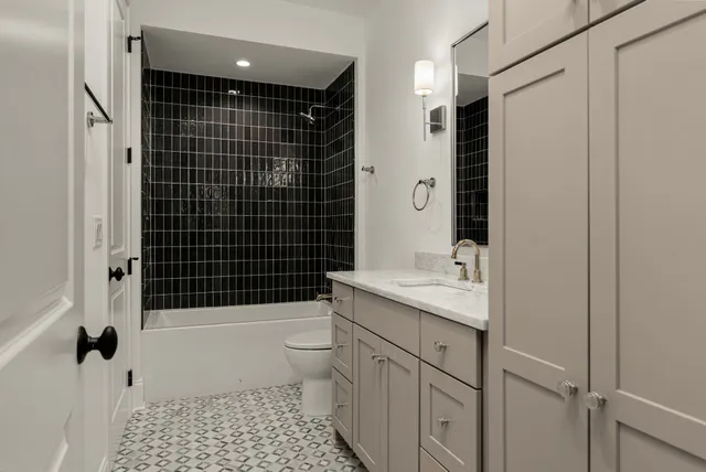 a bathroom with a sink a toilet and shower