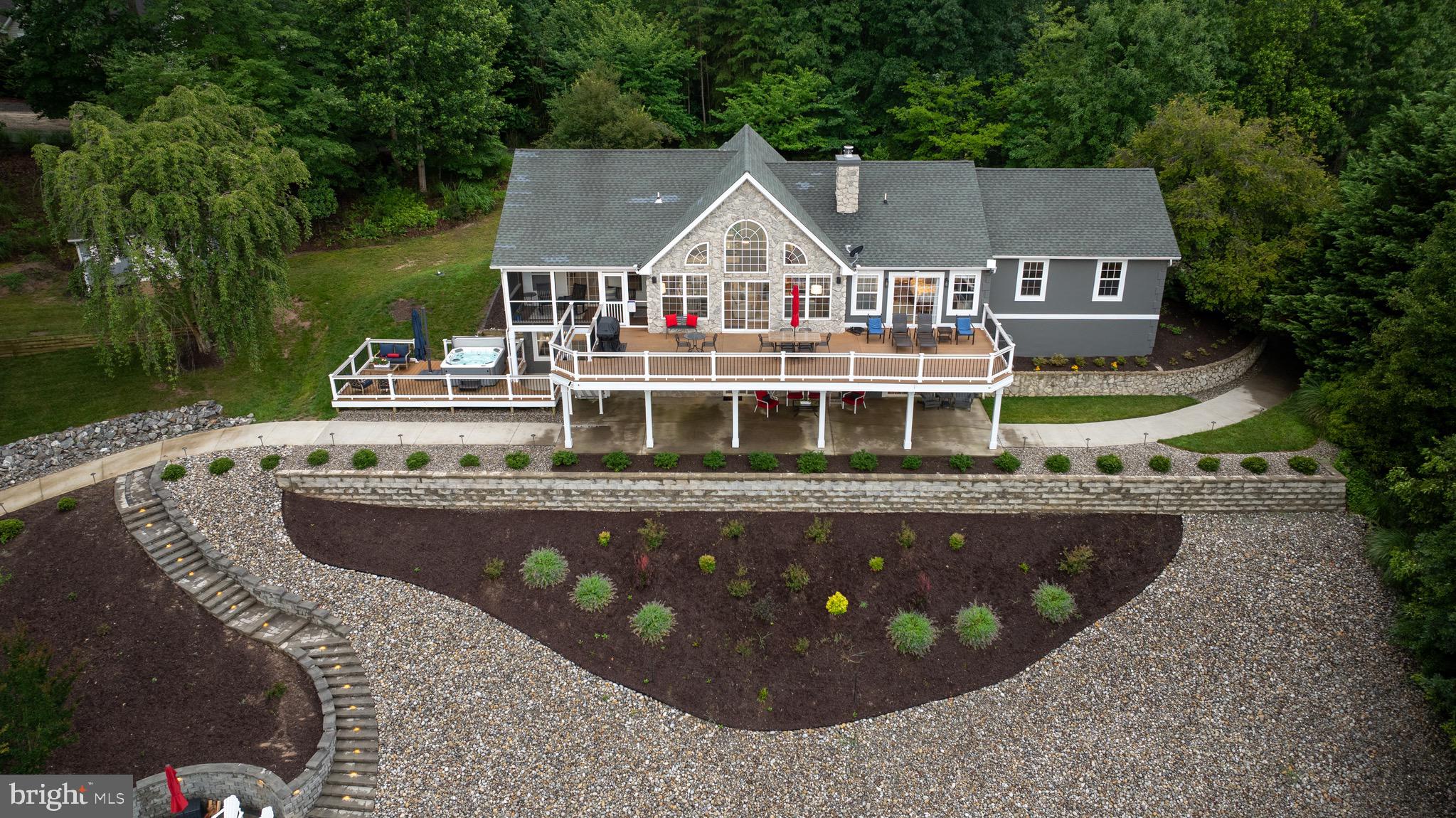 1069 Mitchell Point Road Mineral, VA 23117 - Photo 109 of 110 a view of a house with pool and trees in the background