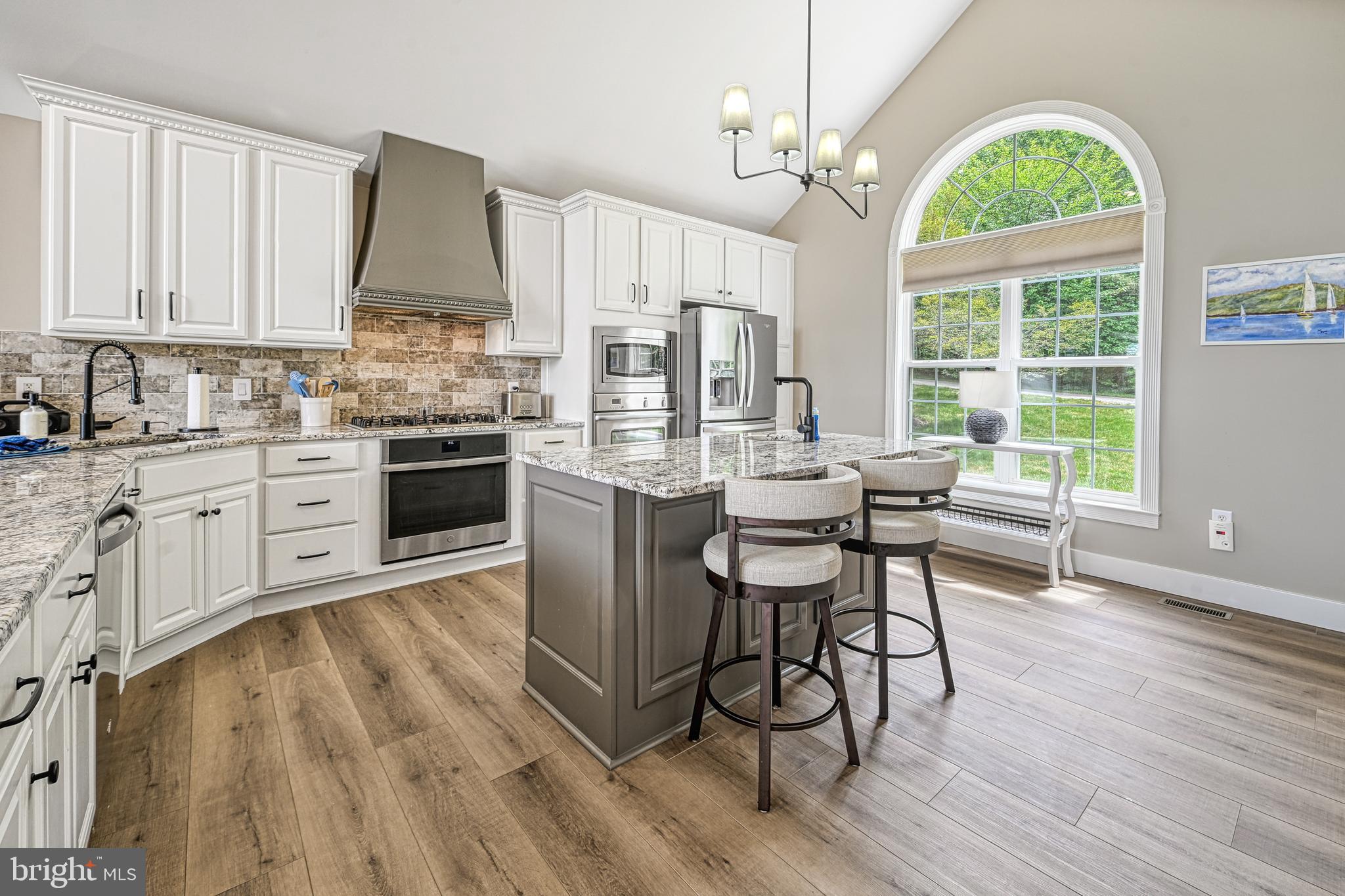 1069 Mitchell Point Road Mineral, VA 23117 - Photo 25 of 110 a kitchen with stainless steel appliances granite countertop a stove top oven a sink dishwasher a dining table and chairs with wooden floor