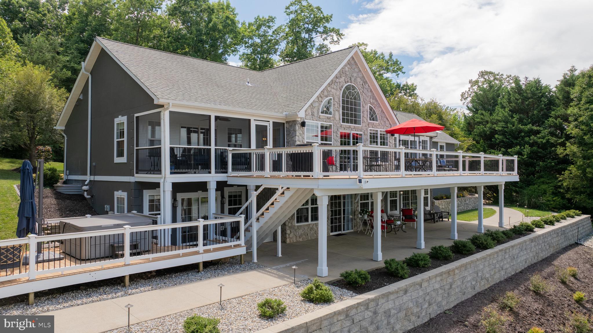 1069 Mitchell Point Road Mineral, VA 23117 - Photo 3 of 110 a view of a house with large windows and a white roof